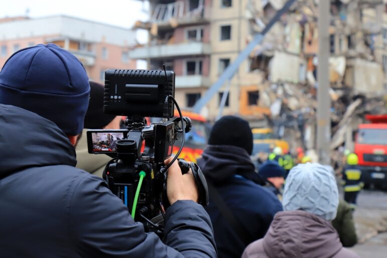 war crimes self-care trauma Cameraman filming a broken destroyed house in Ukraine after Russian missile strike. The news agency is broadcasting live from scene of explosion. City Dnipro. Russia war against Ukraine